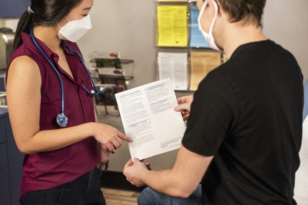 Infirmière et un patient discutant à propos d'un document